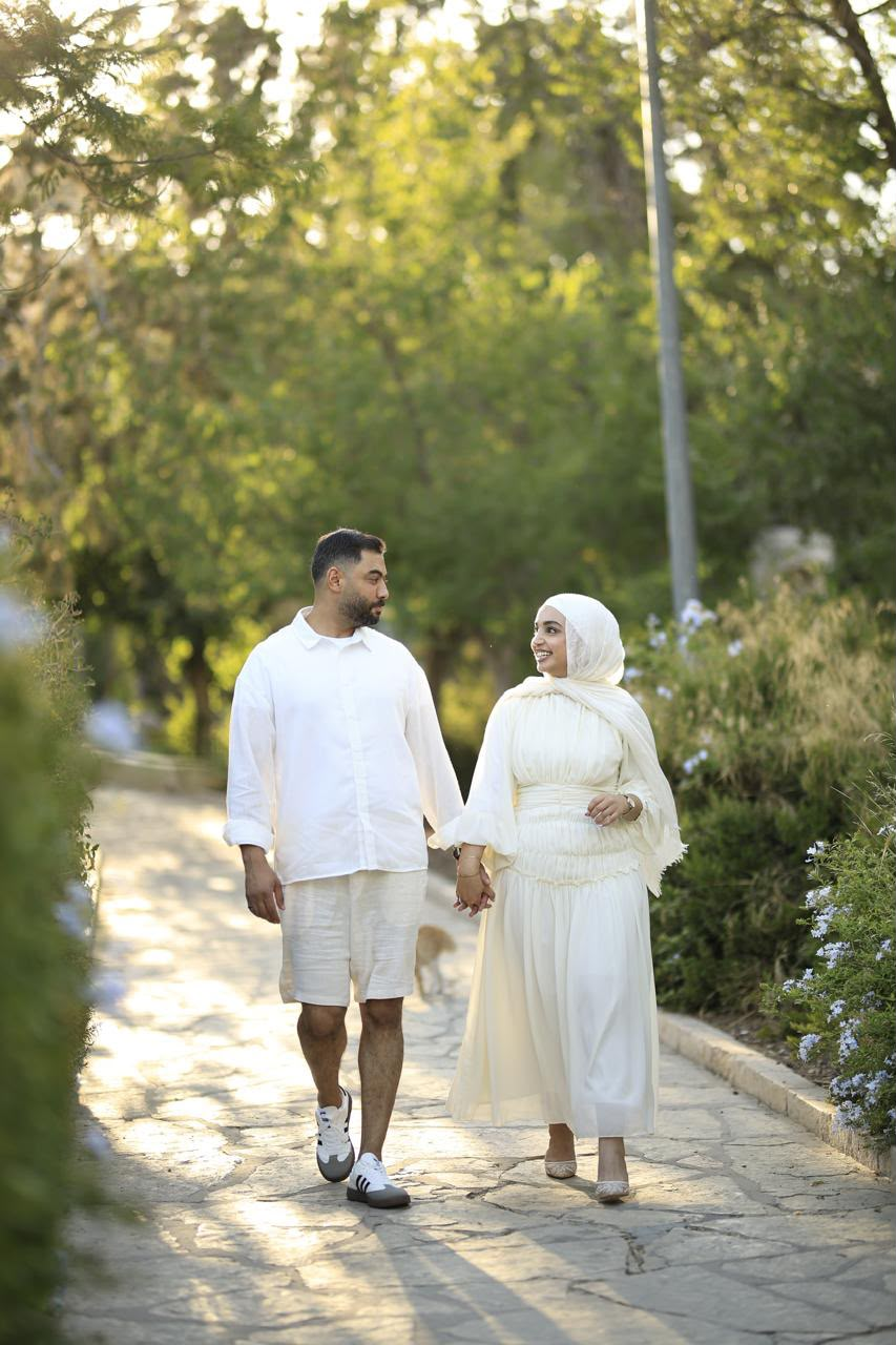 Basel and Rafeef strolling together at golden hour
